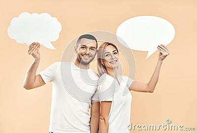 Smiling woman and man holding paper thought bubbles Stock Photo