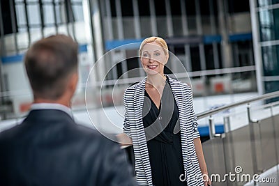 Smiling woman and meeting man in airport Stock Photo