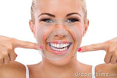 Smiling woman pointing in her perfect teeth Stock Photo