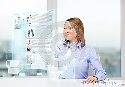 Smiling woman pointing to news on virtual screen Stock Photo