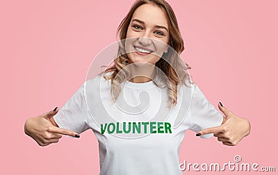 Smiling woman pointing at volunteer writing Stock Photo