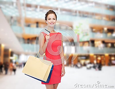 Smiling woman with shopping bags and plastic card Stock Photo