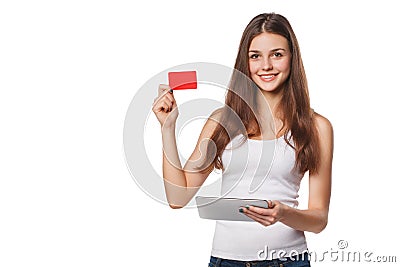 Smiling woman showing blank credit card hold tablet pc in hand, in white t-shirt, isolated over gray background Stock Photo