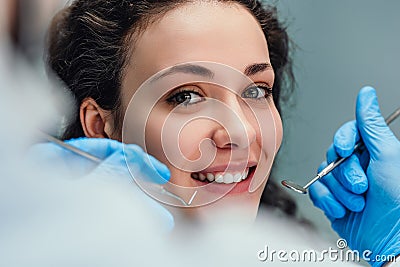 Smiling woman sitting in dentist chair ready for a dental check-up. Close up view Stock Photo