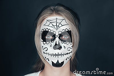 Smiling woman with sugar skull makeup Stock Photo