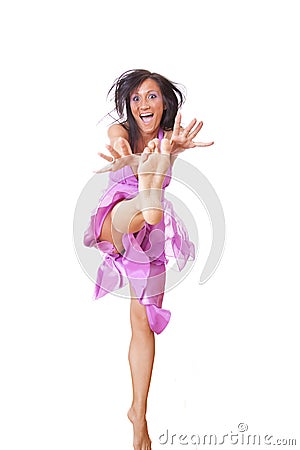 Smiling Woman In Violet Silk Dress Jumping Stock Photo