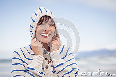Smiling woman wearing hooded sweater during winter Stock Photo