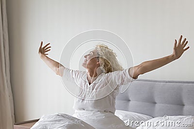 Smiling woman welcomes new happy day feel refreshed after sleep Stock Photo