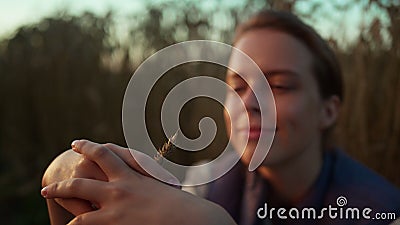 Smiling woman wheat field portrait. Farmer hands holding spikelet close up. Stock Photo