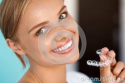 Smiling Woman With White Teeth Holding Teeth Whitening Tray Stock Photo