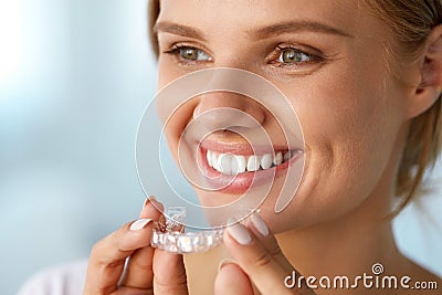 Smiling Woman With White Teeth Holding Teeth Whitening Tray Stock Photo