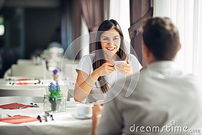 Smiling woman on a date in a restaurant,having a conversation over a meal in hotel.Positive emotions,love,affection Stock Photo