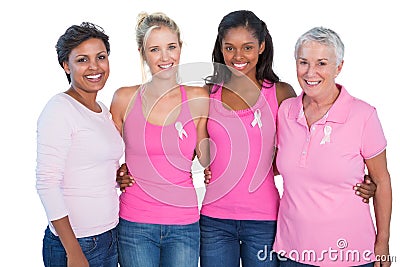 Smiling women wearing pink tops and breast cancer ribbons Stock Photo