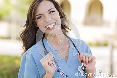 Smiling Young Adult Woman Doctor or Nurse Portrait Outside Stock Photo