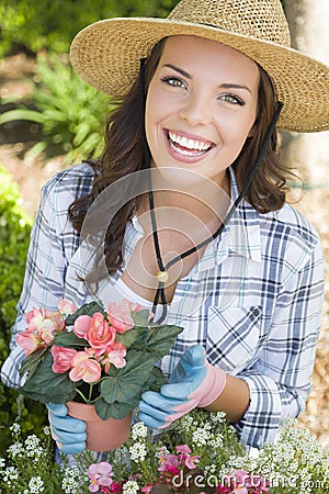 Smiling Young Adult Woman Wearing Hat Gardening Outdoors Stock Photo