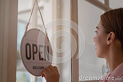 Smiling young asian business owner, employee retail,coffee shop woman,girl turning,setting sign board to open for welcome customer Stock Photo