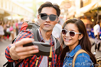 Smiling young Asian couple tourists taking selfie Stock Photo