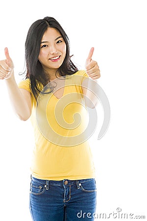 Smiling young Asian woman showing thumb up sign with both hands Stock Photo