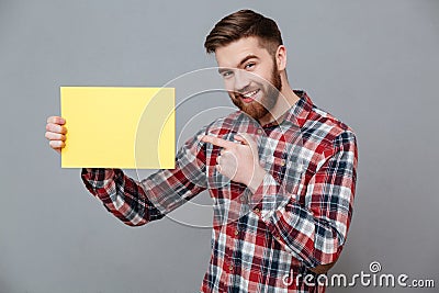 Smiling young bearded man holding copyspace blank Stock Photo