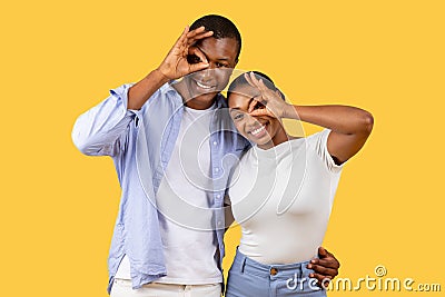 Happy black couple making fun hand gestures Stock Photo