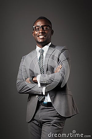 Smiling young black man with glasses and gray business suit Stock Photo