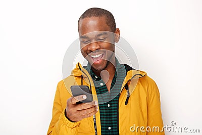 Smiling young black man looking at mobile phone against isolated white background Stock Photo