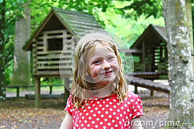 Smiling Young Blonde Girl Playing Out - Wet, Messy, Dirty, Bedraggled and Happy Stock Photo