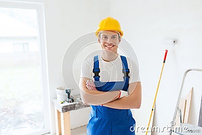 Smiling young builder in hardhat indoors Stock Photo