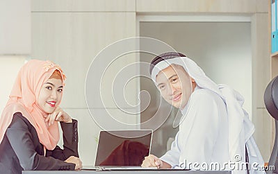 Smiling young business arab middle eastern meeting working in office and looking at camera Stock Photo