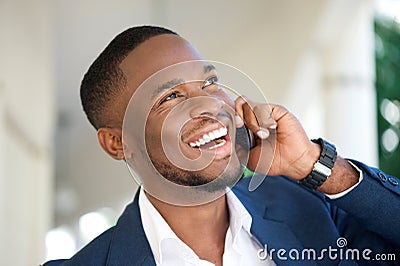 Smiling young businessman calling by mobile phone Stock Photo