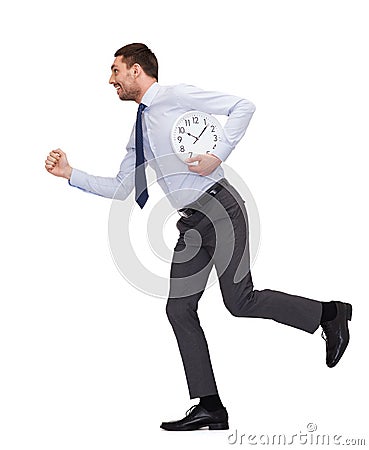 Smiling young businessman with clock running Stock Photo