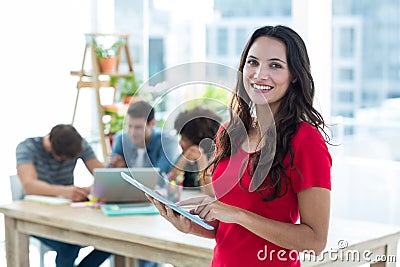 Smiling young businesswoman using tablet Stock Photo