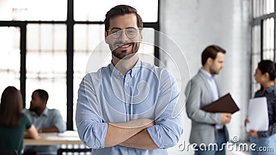 Smiling male CEO posing alone in modern office Stock Photo