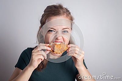 Smiling young Caucasian woman girl holding eating fried chicken drumstick Stock Photo