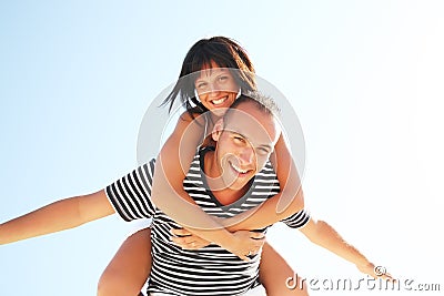 Smiling young couple having fun at the beach Stock Photo
