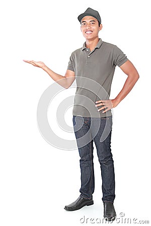 Smiling young delivery man presenting Stock Photo