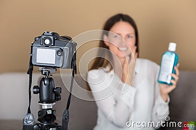 Female Blogger Holding Product Recording Video With Camera Stock Photo