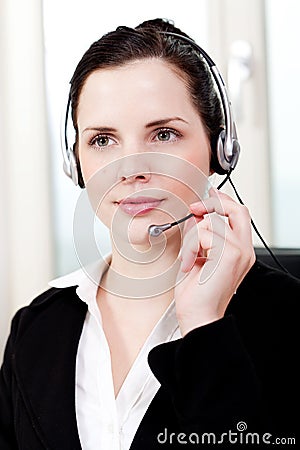 Smiling young female callcenter agent with headset Stock Photo