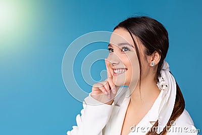 Smiling young female employee look in distance thinking or visualizing career success. Happy businesswoman plan or dream Stock Photo