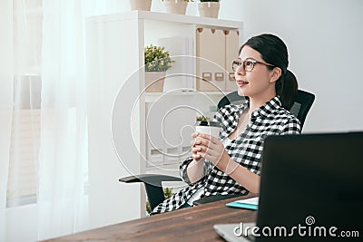 Smiling female soho worker sitting on workspace Stock Photo