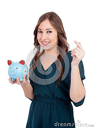 Smiling young girl with a blue money-box Stock Photo