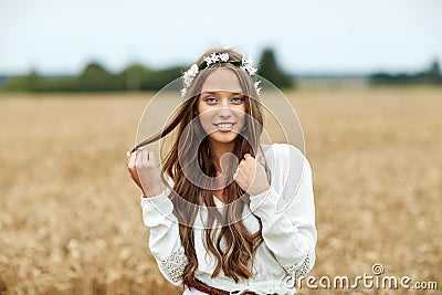 Smiling young hippie woman on cereal field Stock Photo