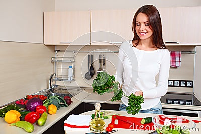 Smiling young housewife mixing fresh salad Stock Photo