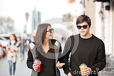 Smiling young lady walking outdoors with her brother Stock Photo