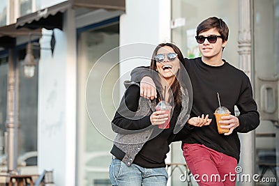 Smiling young lady walking outdoors with her brother Stock Photo