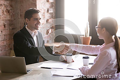 Smiling young male and female handshake after sales Stock Photo