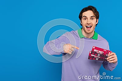 smiling young man showing concert tickets Stock Photo