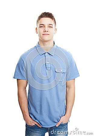 Smiling young man standing with hands in pockets Stock Photo