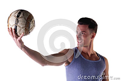 Smiling young man in tanktop holding soccer ball Stock Photo