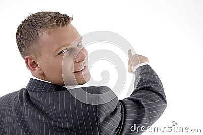 Smiling young manager pointing back side Stock Photo